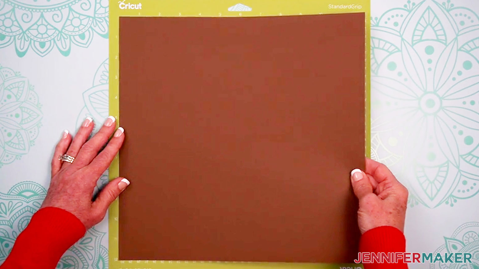 Place a sheet of 12" x 12" 65 pound dark brown cardstock on the green machine mat.