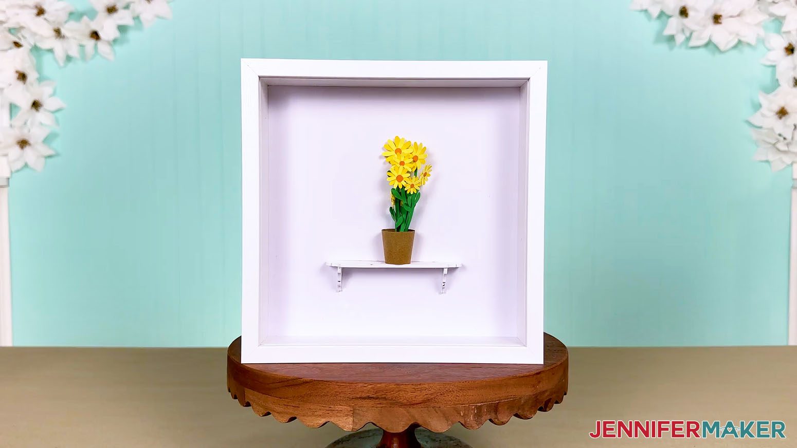 Displayed mini daisies in a shadowbox.