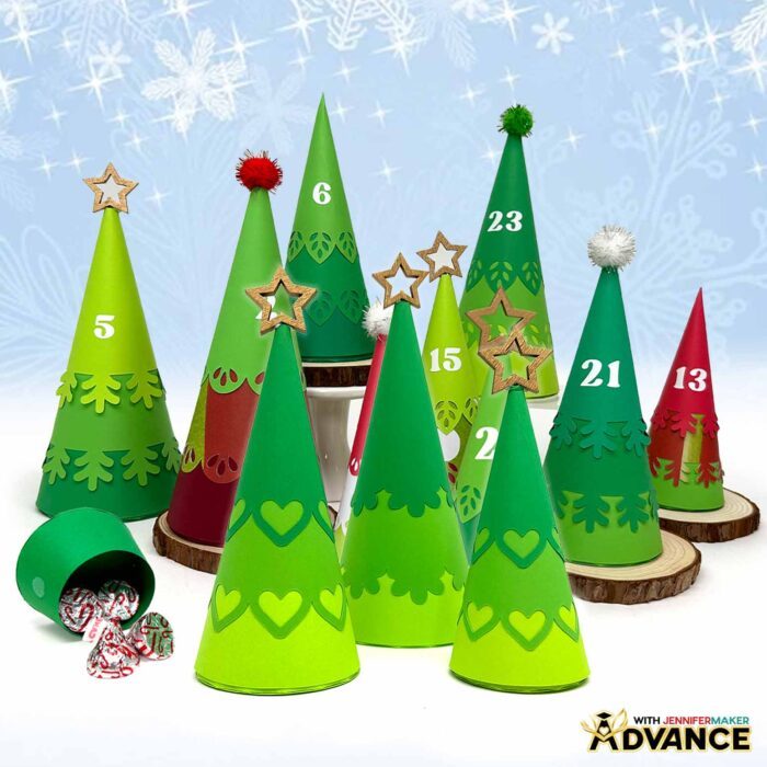 A collection of customized paper Christmas trees in shades of green with red details that make up the Minimalist Tree Advent Calendar project