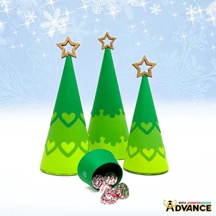 A collection of paper Christmas trees in shades of green with customized toppers in the shape of stars, part of the ADVANCE by JenniferMaker Minimalist Tree Advent Calendar project