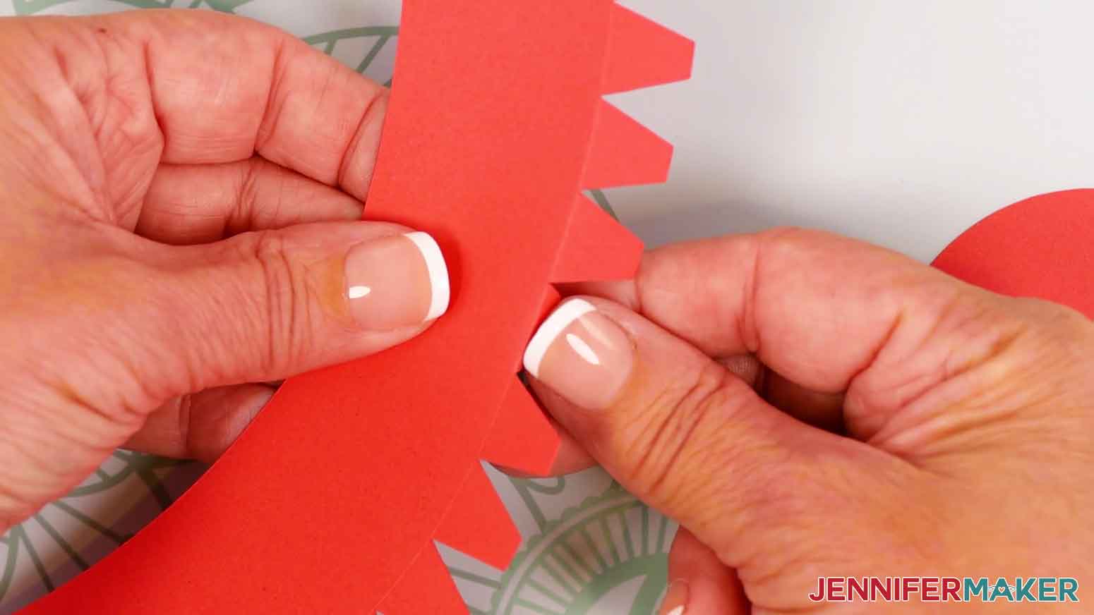 To assemble an advent calendar tree&rsquo;s gift box, fold back the side panel&rsquo;s small bottom tabs.