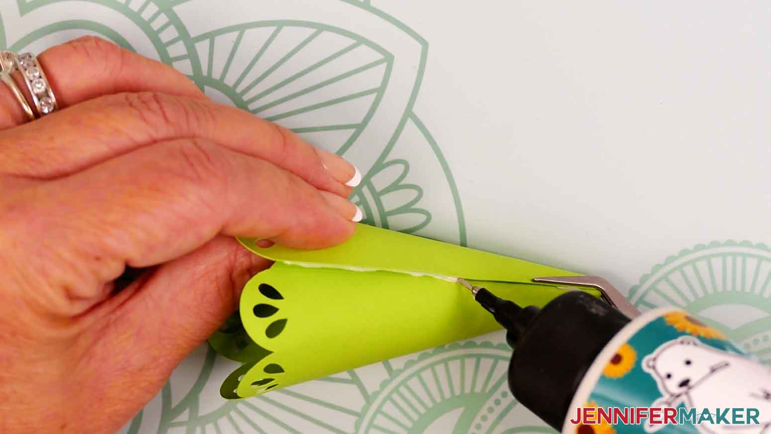 Remove the clothespin from the bottom half and add craft glue where the cardstock overlaps, keeping the edge aligned with the crease line.