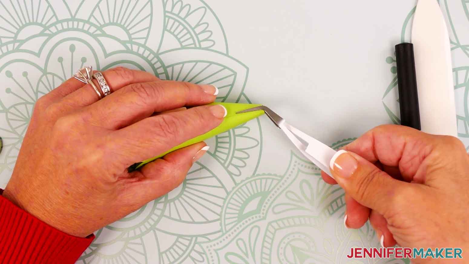 Use your reverse-action tweezers to pinch and hold the tip together until the glue dries on the top half of the tree piece.