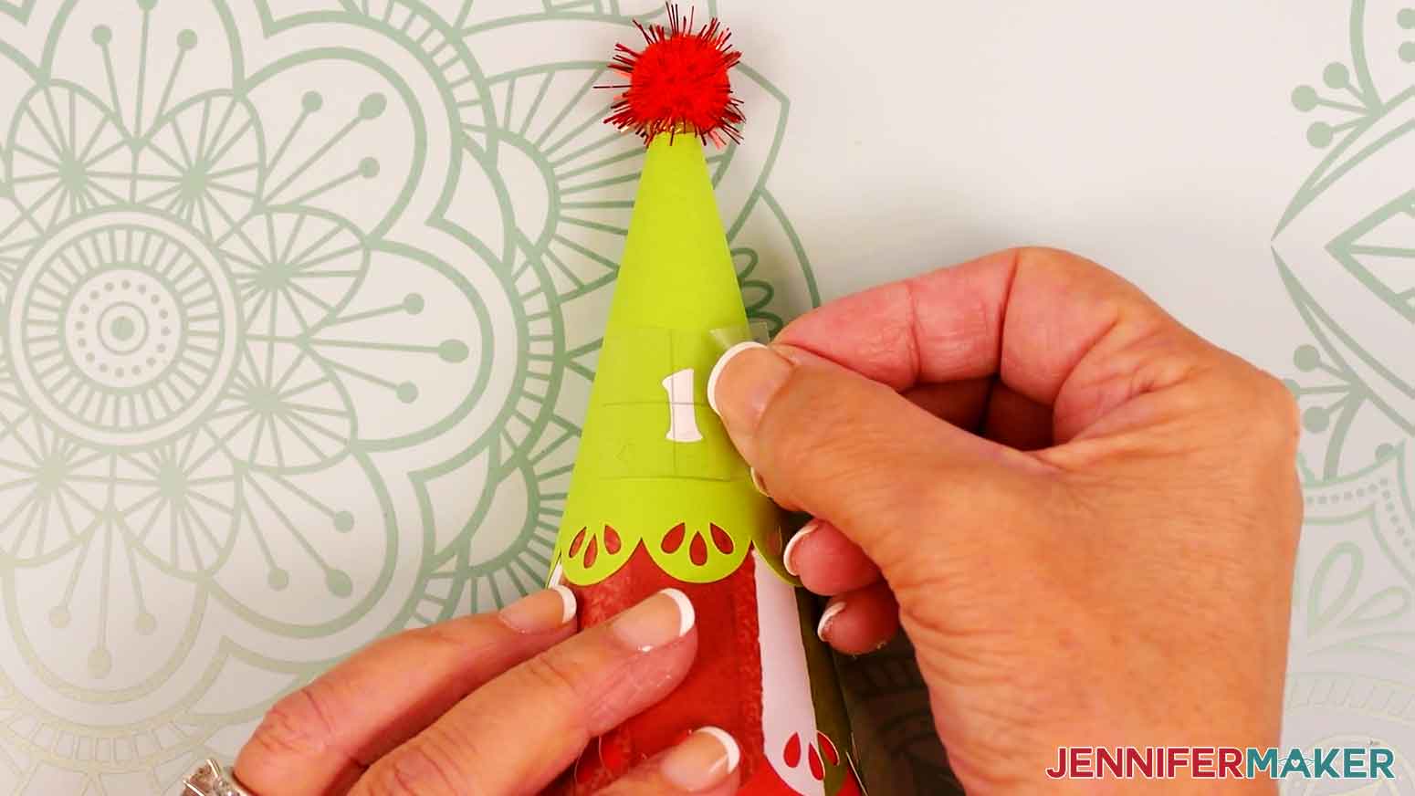 Hold your transfer tape sticky side down and lightly center the vinyl decal on the front of your cardstock tree.