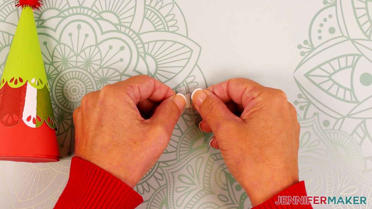 Hold your transfer tape in the shape of a &ldquo;taco,&rdquo; sticky side down, then center the bottom of the &ldquo;taco&rdquo; onto the middle of the vinyl decal.