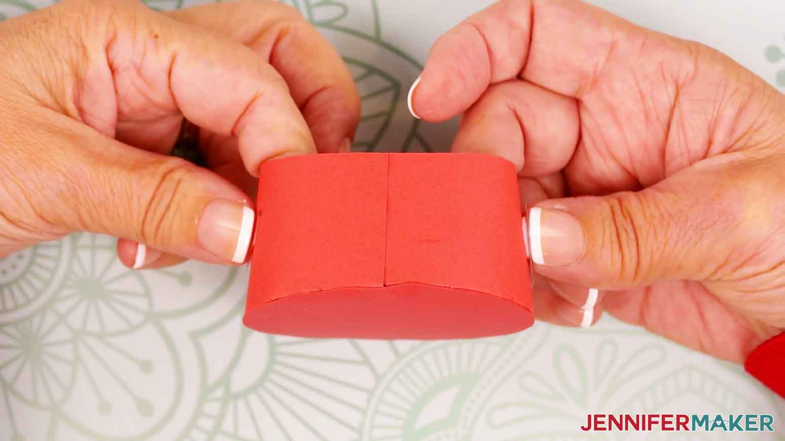Pinch each of the hook and loop dot pieces securely to the tree and gift box cardstock.