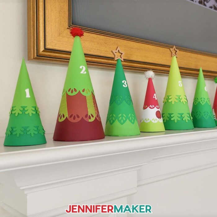Minimalist Tree Advent Calendar project on a fireplace mantel, made up of colorful cone-shaped tree boxes made from cardstock