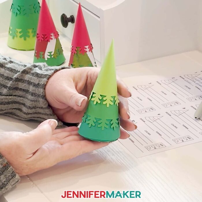Hands show off one of the Minimalist Tree Advent Calendar boxes made up of three layers of green cardstock