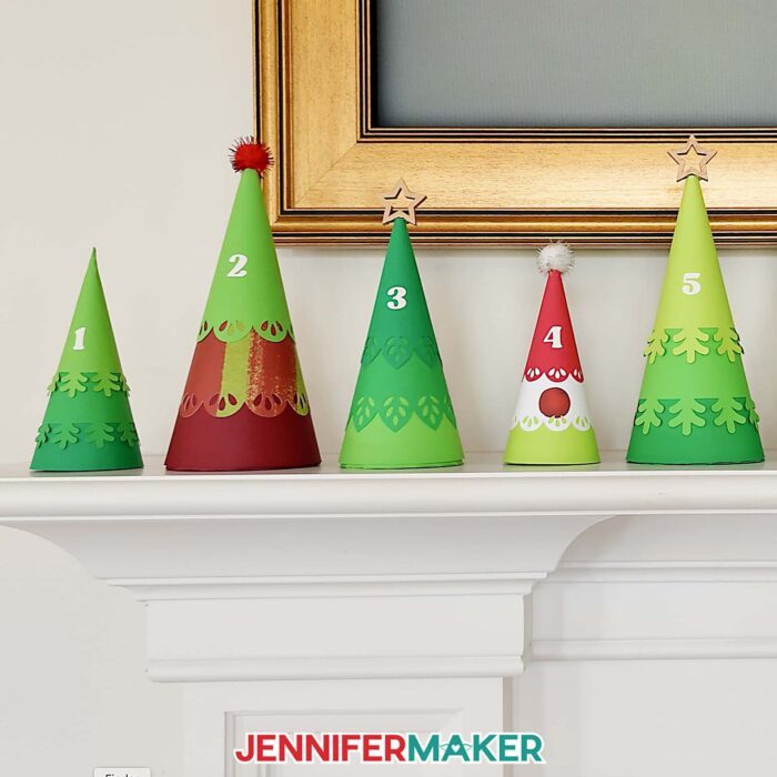 Minimalist Tree Advent Calendar project on a fireplace mantel, made up of colorful cone-shaped tree boxes made from cardstock