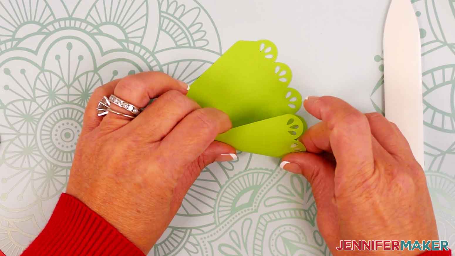 Roll the tree piece&rsquo;s edges inward to form a cone shape.