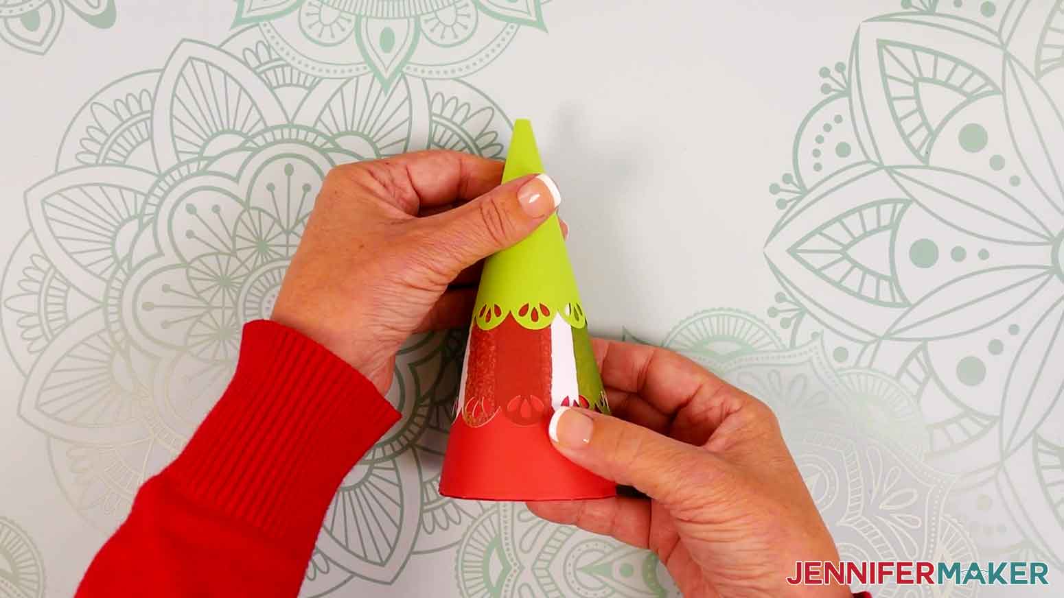 Place the advent calendar tree's bottom piece on top of the gift box, then stack the middle piece on top of the bottom, followed by the top piece.