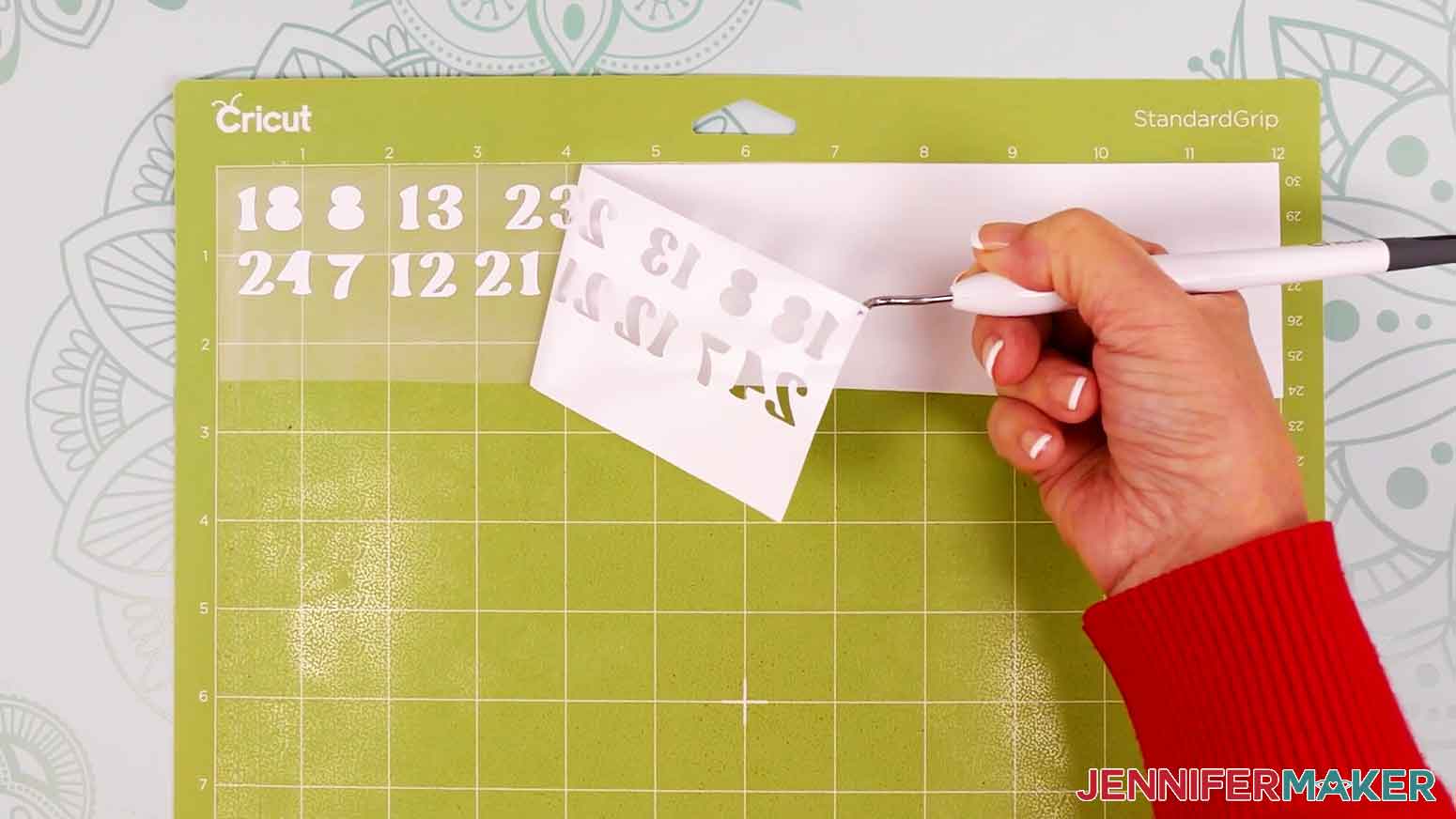 Use your weeding tool to carefully peel away the extra background vinyl.