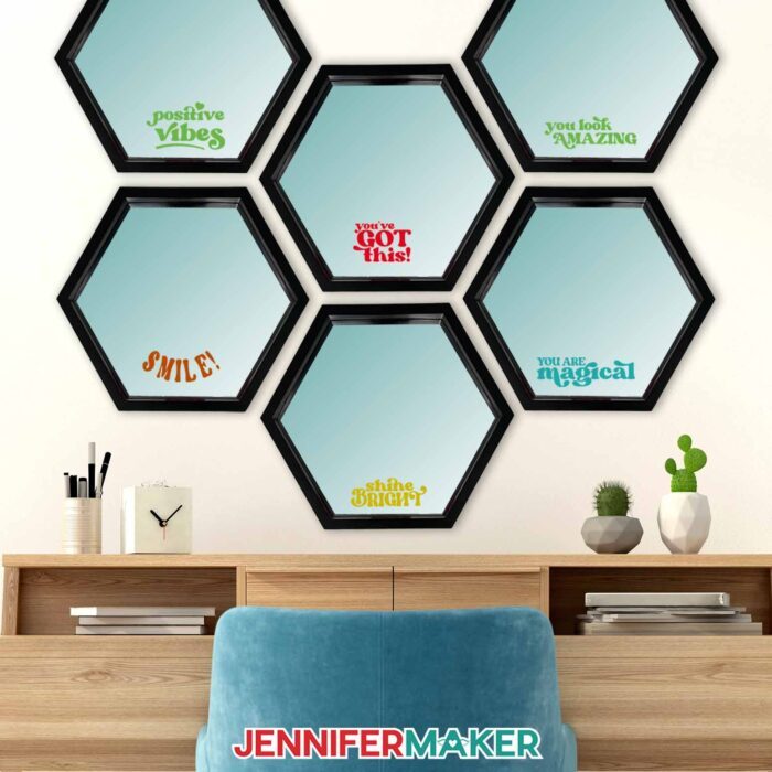 Mirrors in the shape of hexagons hang above a desk, decorated with colorful messages cut from Cricut Value Vinyl.