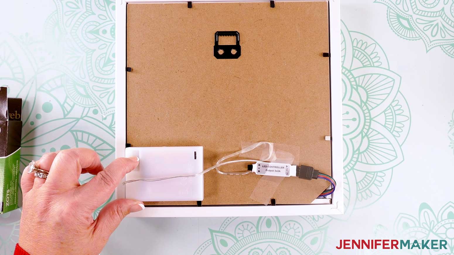 Attaching the battery pack and control to the back of the frame to make a Northern Lights Shadow Box