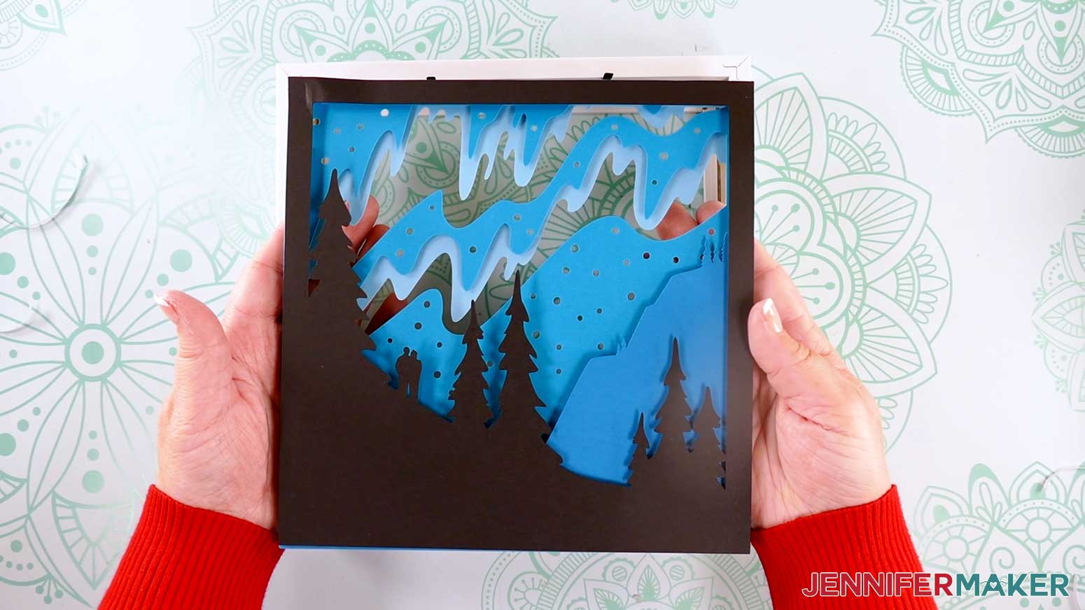 Showing the cardstock layers in order before placing into the frame to make a Northern Lights Shadow Box