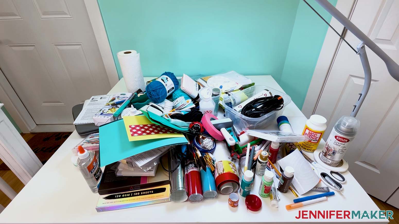 All items from the messy craft cart are piled on the work table.