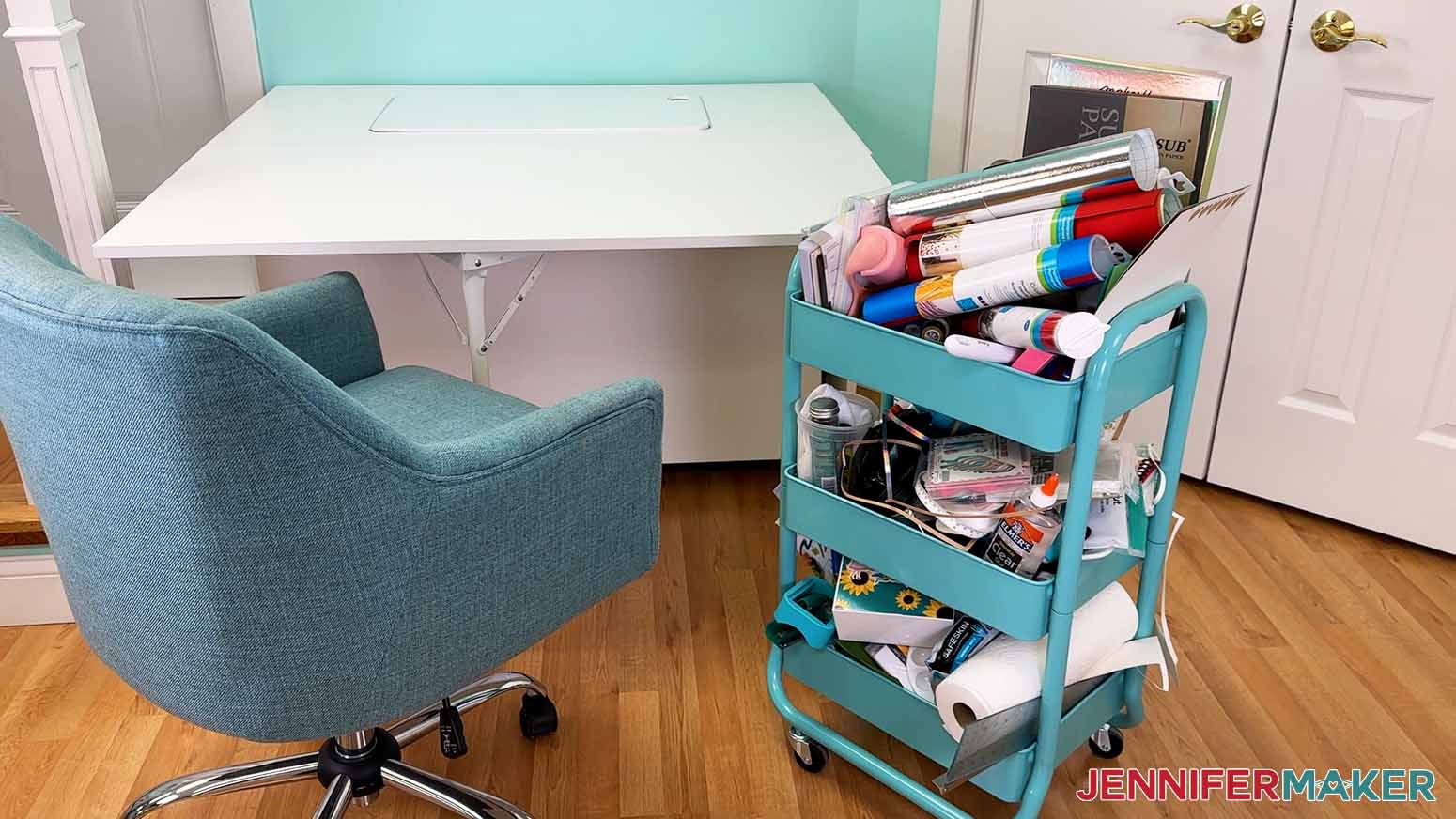 Disorganized craft cart next to work table.