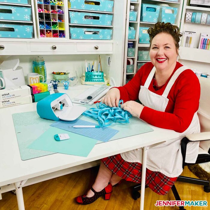 Jennifer Maker at her organized DreamBox with a blue paper snowflake and the Cricut Joy