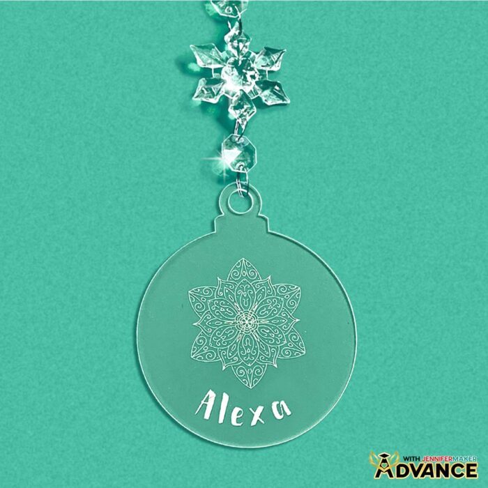 Engraved acrylic ornament with a snowflake and a filled-in name Alexa. Learn how to do Acrylic Engraving with a Cricut in the free tutorial!