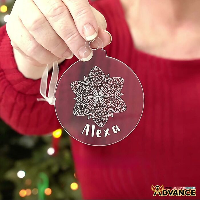 Hands hold an Acrylic Engraving ornament with a custom name "Alexa" engraved on it with filled letters