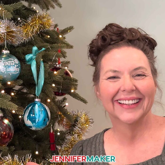 Jennifer shows off a beautiful blue alcohol ink ornament hanging on the tree.