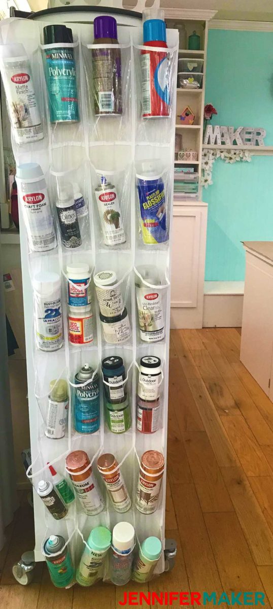 Over the door storage for craft supplies - shoe holder with cans of spray paint and spray adhesive