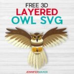 Free 3D Layered Owl SVG by JenniferMaker - Framed papercraft layered owl made of tan, brown, black, and yellow cardstock with spread wings under the words Free 3D Layered Owl SVG on a gray background