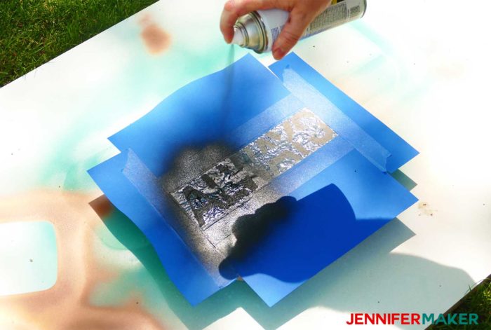 Spray paint over the stencil on your cement stepping stone
