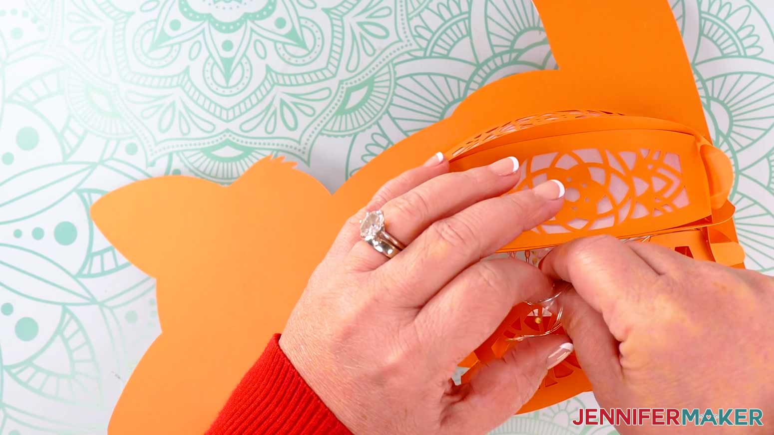 Place the coil of fairy lights and the battery pack inside the open panel of the fox paper lantern.
