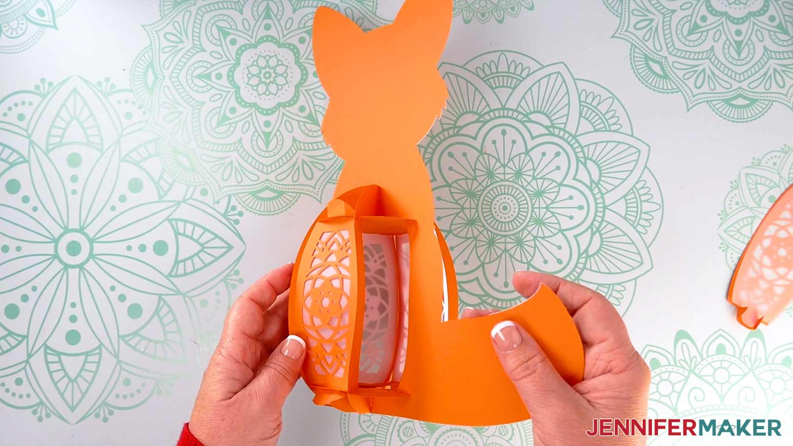 Rotate the fox lantern's body frame so the back side is facing you, and insert two of the orange back panels, leaving one panel open.
