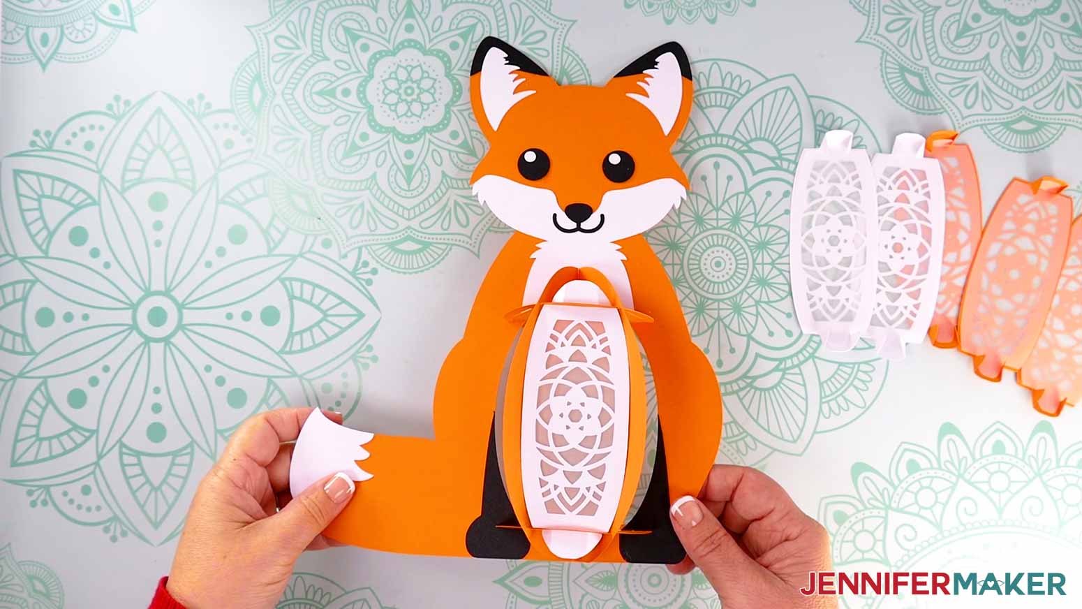 Insert the first white front panel's top and bottom tabs into the slots on the front section of the fox lantern's frame.