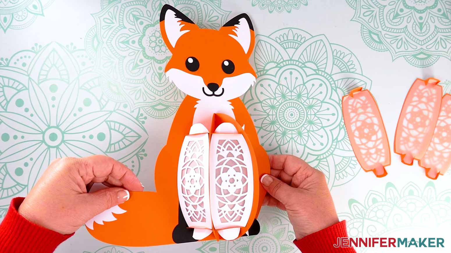 Insert the white front panels' top and bottom tabs into the fox lantern frame&rsquo;s top and bottom base slots.