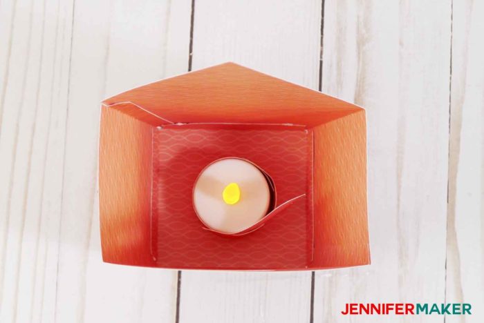 Place the LED tealight with the paper bird inside your paper birdhouse