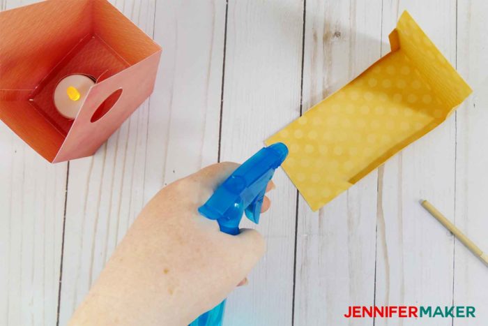 Spray the edges of your roof lightly if you have issues rolling them for your paper birdhouse