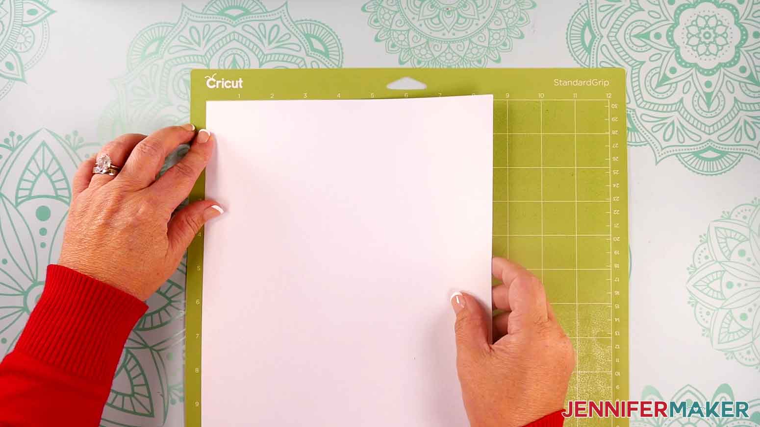 Place a piece of white 8.5" x 11" cardstock on the green machine mat.