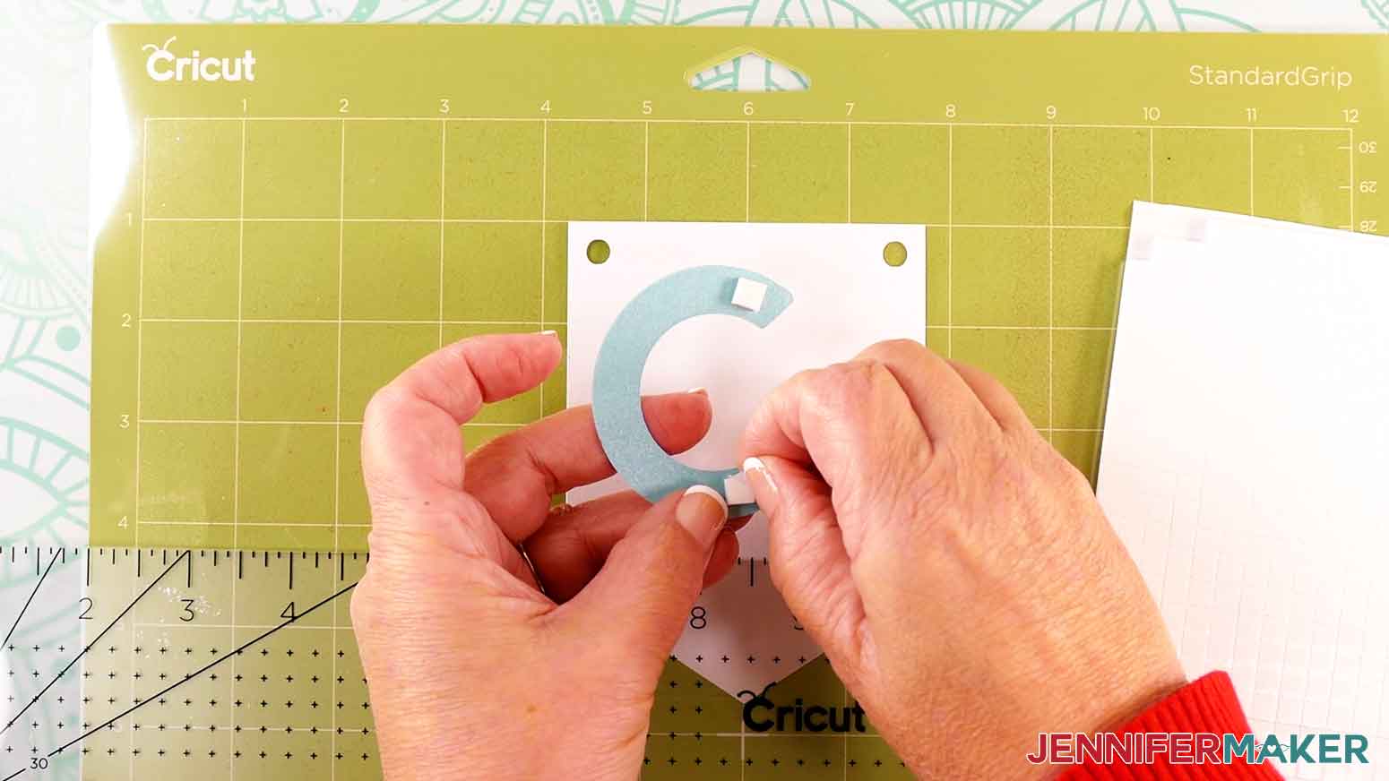 Place two foam adhesive squares on the back side of the letter C for the congrats banner.