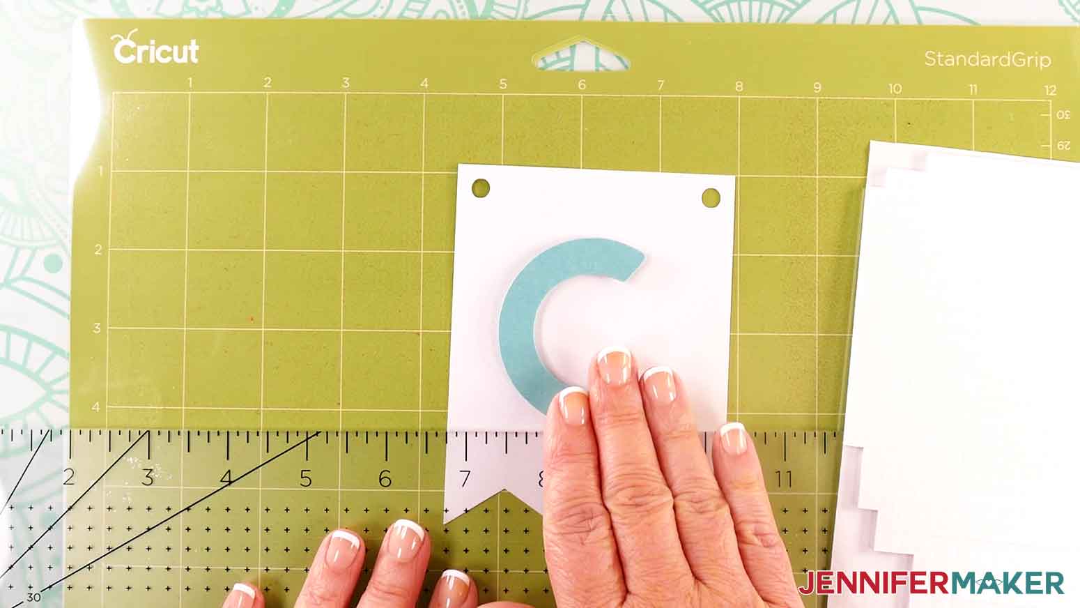 Remove the covers to the foam adhesive and press the letter in to place on the white panel.