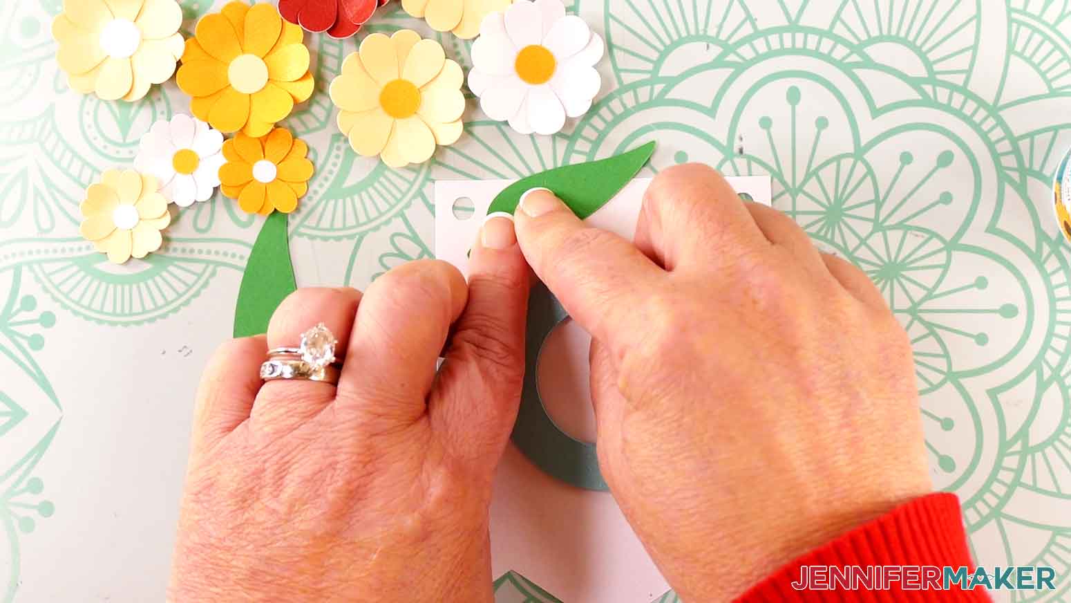 Press the petal to the upper left corner of the banner panel with a C leaving the circle uncovered.