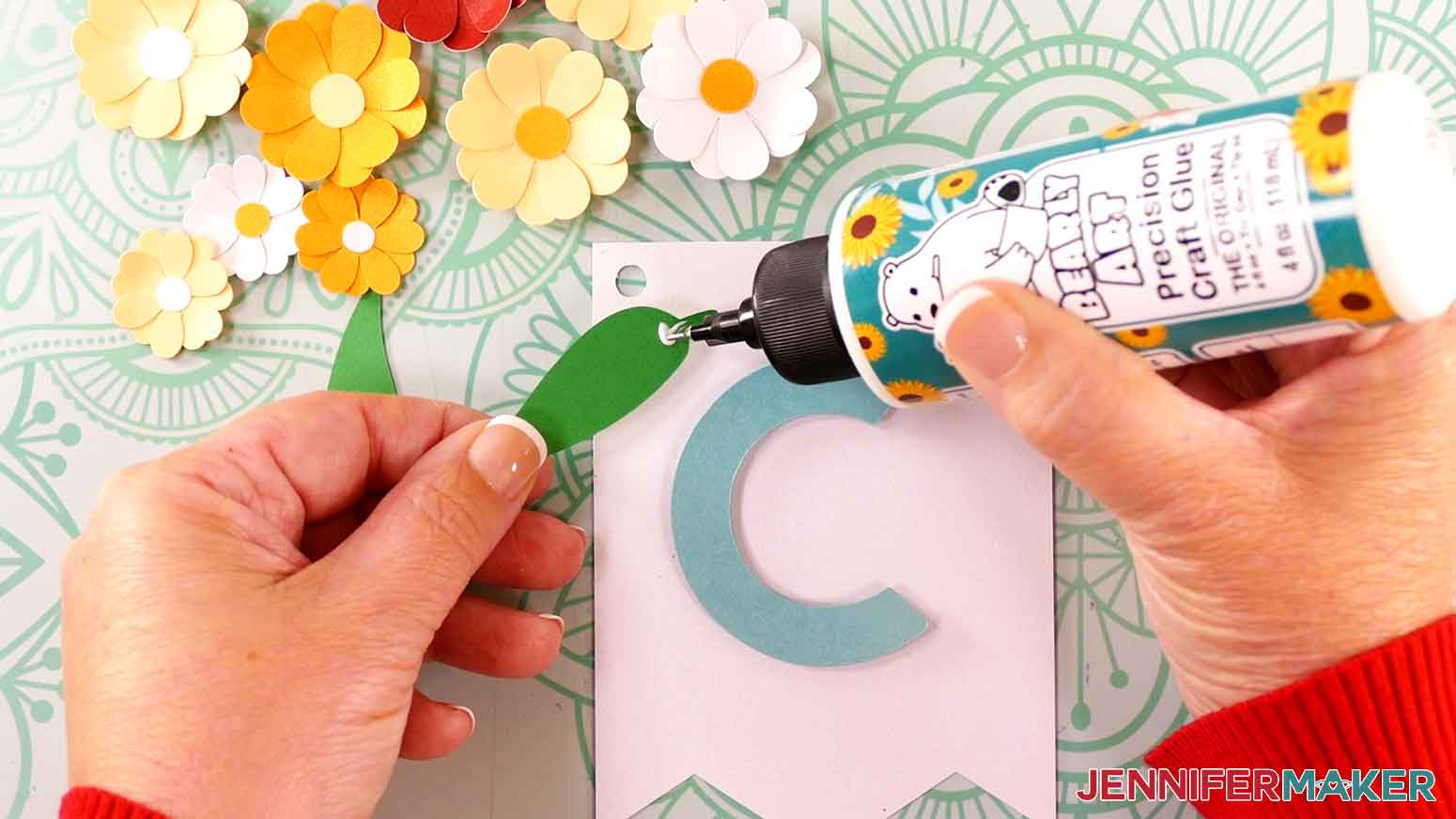 Apply a small dot of glue to the back of the petal near the stem.