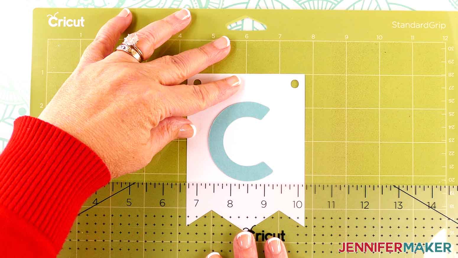 Use a ruler to align the letter piece with the banner panel.