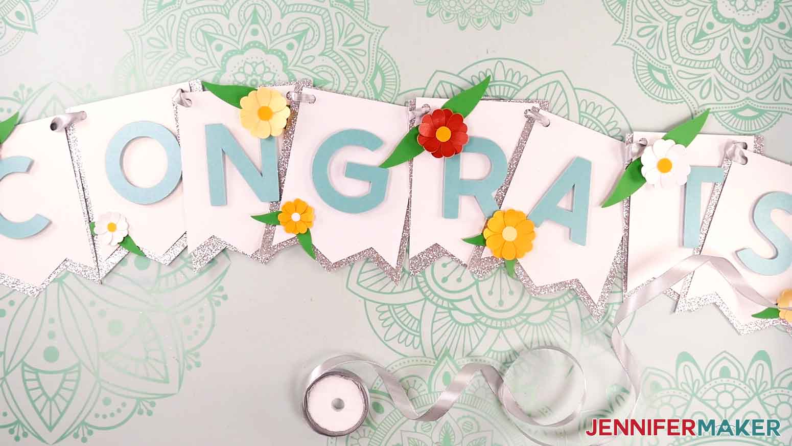 Silver ribbon strung through the congrats banner and ready for display.