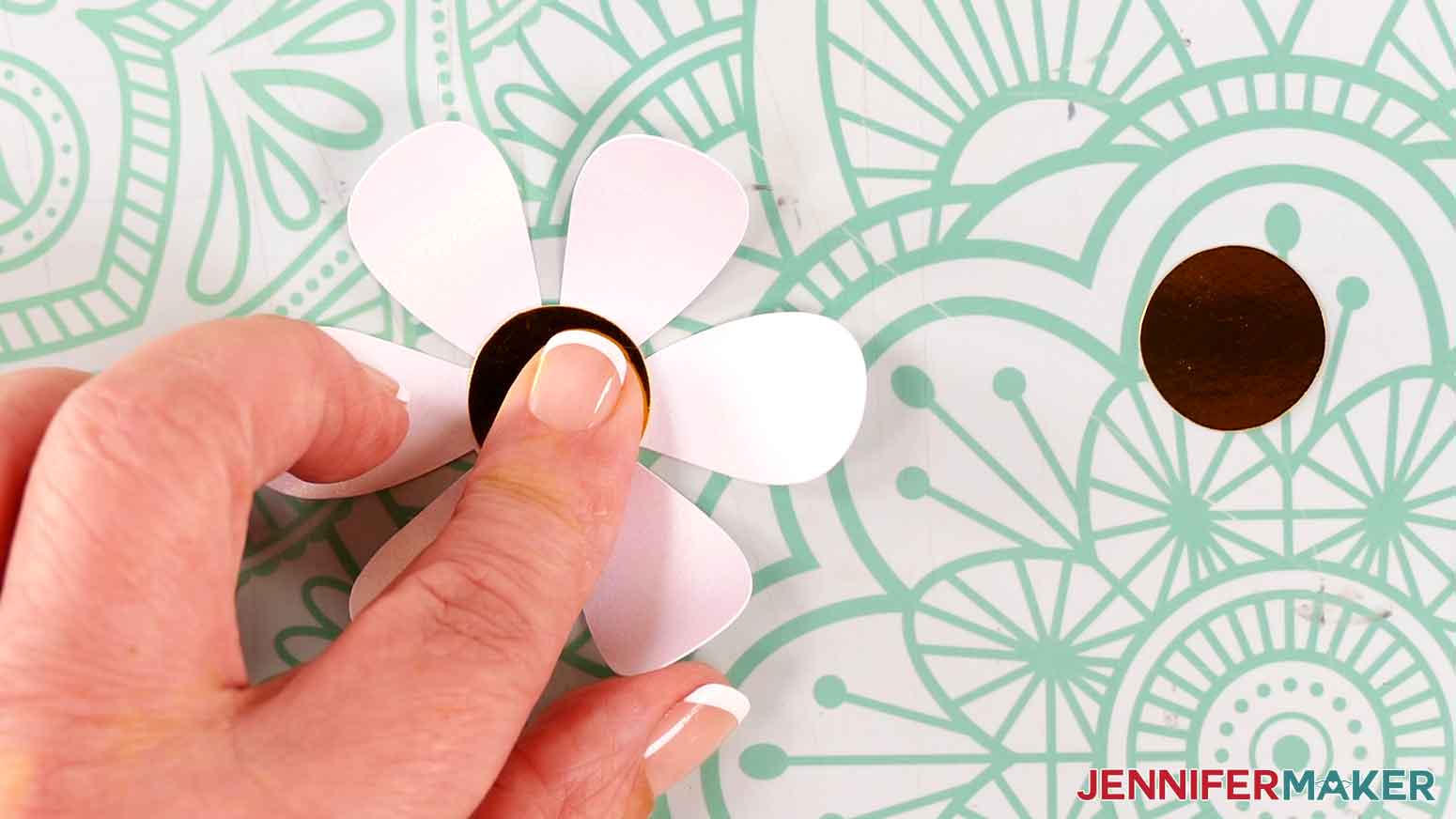 Press the holographic yellow circle to the center of the white flower to adhere the glue.