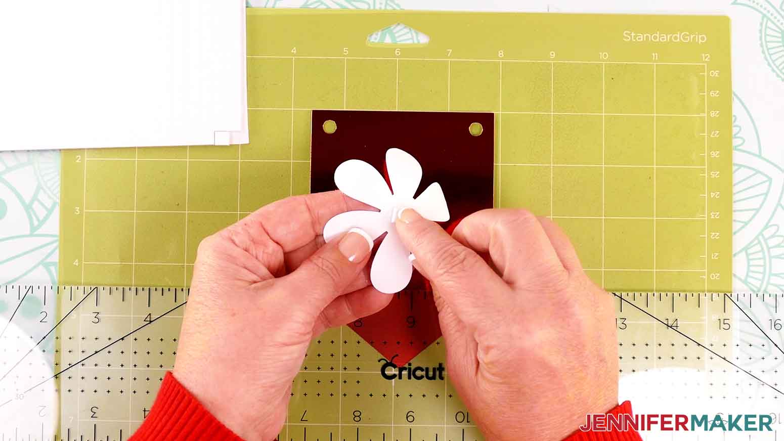 Apply a foam adhesive square to the back side of the flower accent.