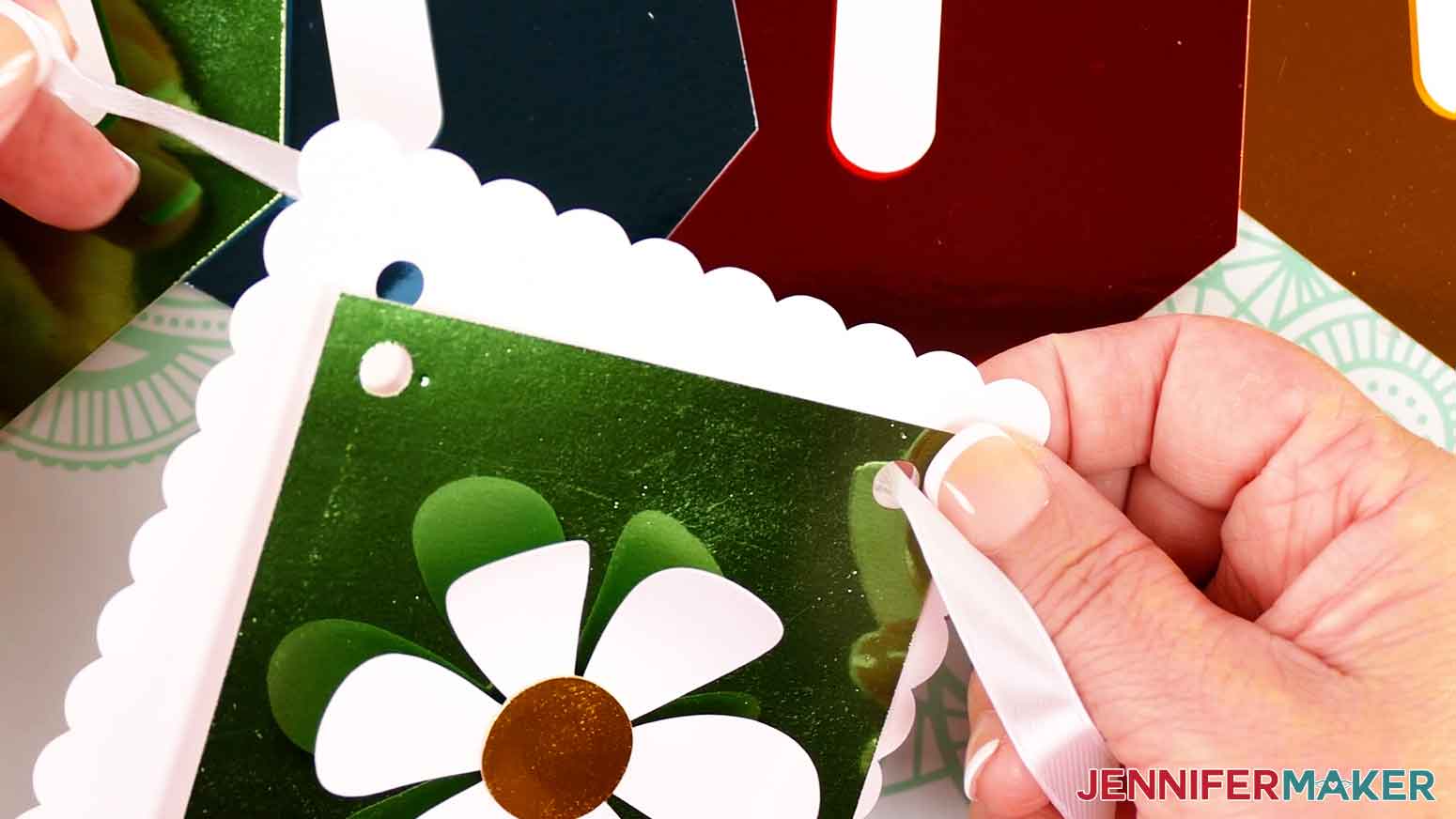 Insert ribbon down through the right hole of the banner panels.