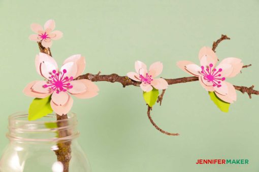 Paper cherry blossom flowers on a branch