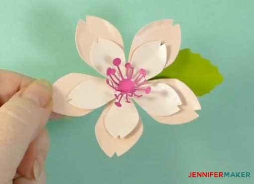 Glue a leaf under the petals to finish off your paper cherry blosssom flower