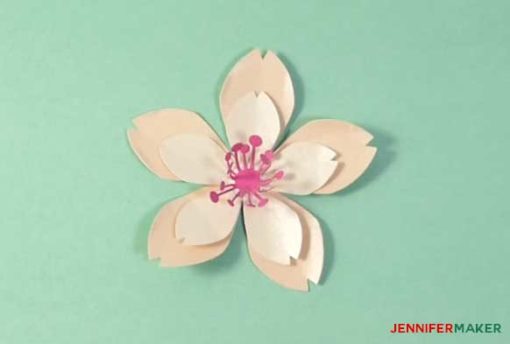 Glue a stamen to the center of your petals to make your paper cherry blossom flower