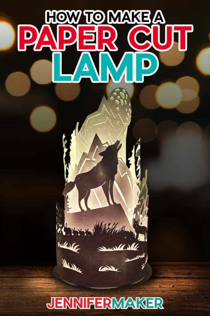 Pinterest link for an illuminated paper cut lamp showing a wilderness wolf scene tutorial.