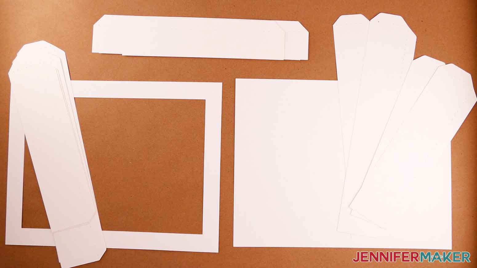 The cut pieces for the DIY cardstock frame for the paper cut light box tutorial