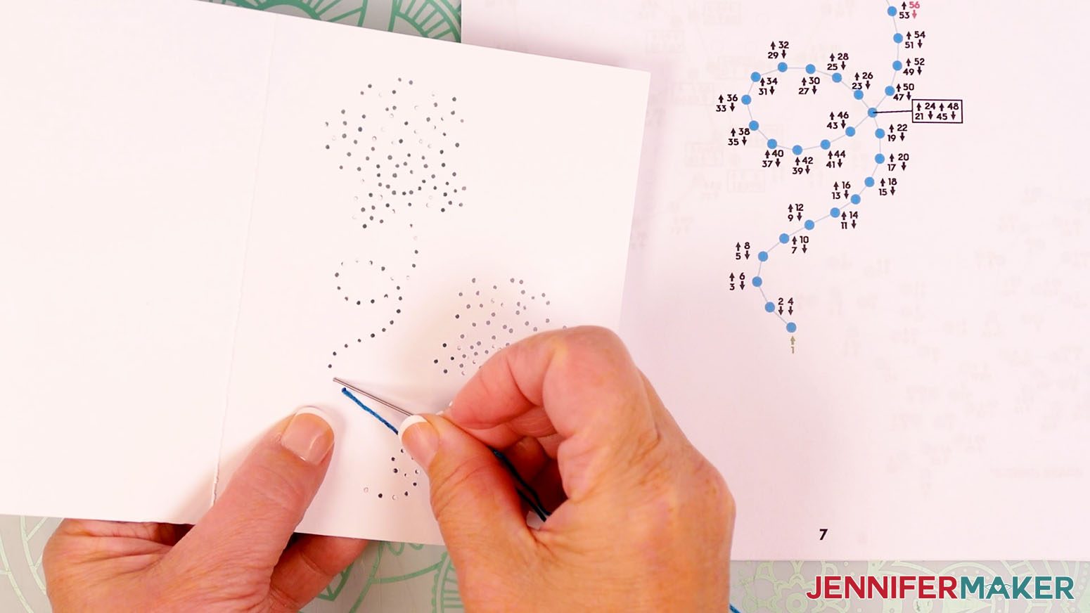 Insert the needle down through hole two and pull the embroidery floss all the way through the hole.